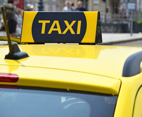 Taxi sign on the top of a car