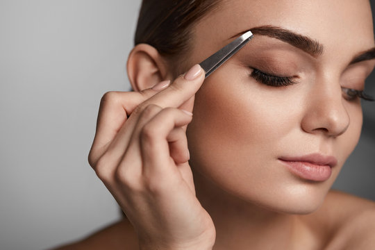Woman With Closed Eyes And Tweezers For Eyebrows. Beauty Tools