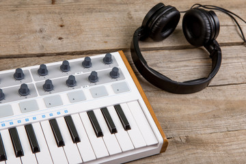 Close up of MIDI controller volume fader, knob and keys.