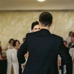 Romantic couple of newlyweds first dance at wedding reception