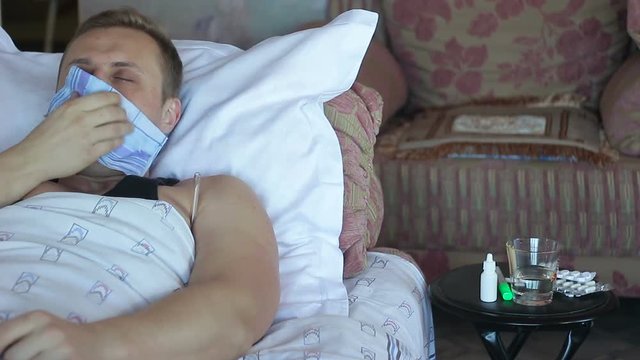 A man with a flu, runny nose and cough.