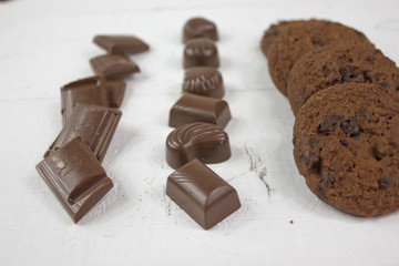 Chocolate biscuits with milk chocolate on white wood