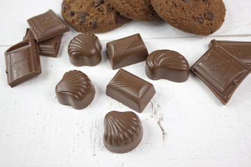 Chocolate biscuits with milk chocolate on white wood