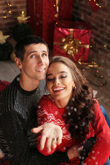 Obraz na płótnie Canvas Christmas photo of beautiful tender couple, in cozy clothes celebrating New Year holidays
