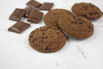 Chocolate biscuits with milk chocolate on white wood