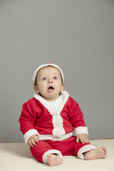 Caucasian baby in Santa Clothes isolated inside studio