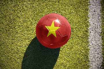 football ball with the national flag of vietnam lies on the field