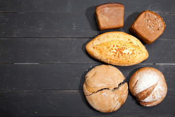 Homemade bread on a black wooden background