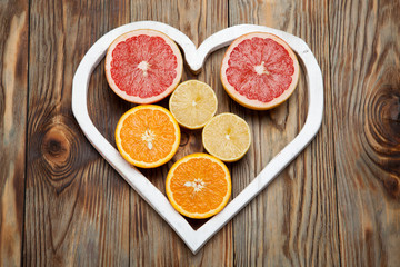 Citrus fruit in a heart on  wooden background