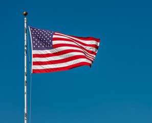 American Flag Against a Clear Blue Sky