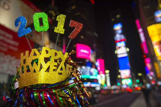 Colorful 2017 Happy New Year message with celebration tinsel flying on novelty party crown in Times Square, New York City