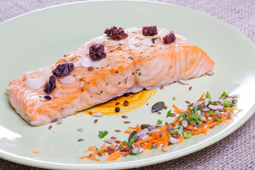 close up salmon steak on a green plate