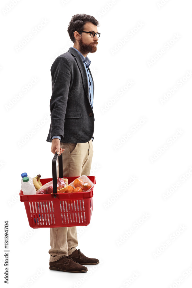 Poster man with a shopping basket full of groceries waiting in line