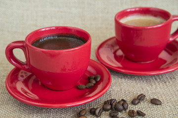 red cups of coffee on sackcloth background