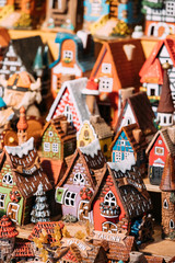 Fototapeta premium Traditional Souvenirs Small House Toys At European Market. Funny Souvenir From Tallinn, Estonia,