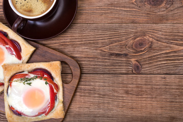Red pepper and baked egg galettes and cup of coffee.