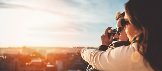 Couple taking pictures on the rooftop