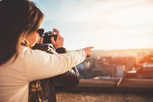 Couple taking pictures on the rooftop
