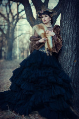 portrait of fairy girl in furs in the autumn forest