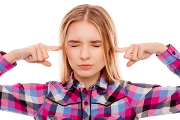 Unhappy woman with closed eyes covering ears with fingers