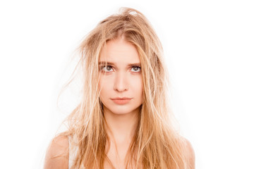 Portrait of upset young blonde woman woman with damaged hair