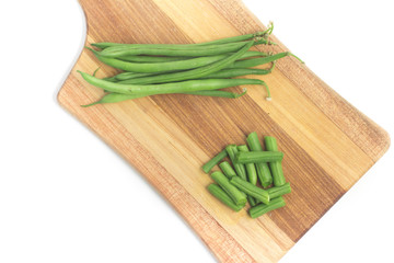 Green Beans Pods over a wooden board. Slim