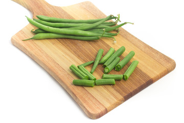 Green Beans Pods over a wooden board. Slim