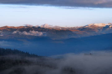 Fog in the mountains. View of the mountains in the distance.