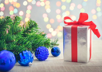 Decorative red gift box with a large silver bow and background b