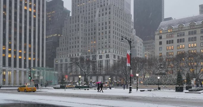 NEW YORK - Circa December, 2016 - A morning wintry establishing shot of traffic and upscale businesses on 5th Avenue near Central Park in Manhattan.	 	