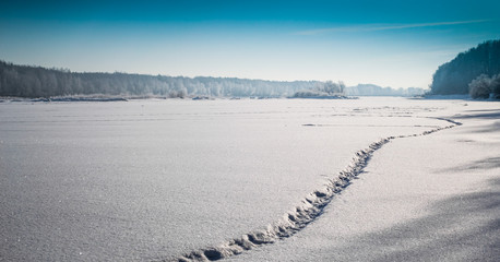 winter landscape. fishing trail on frozen river