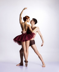 Young ballet dancers on a white background