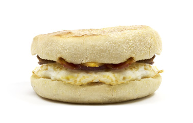 Unwrapped egg muffin sandwich with cheddar cheese and bacon.
