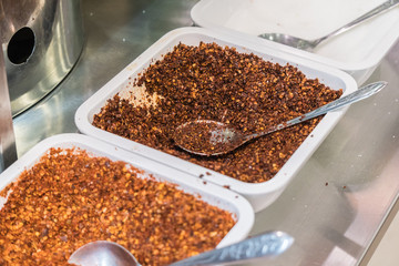 Ground red pepper and dried peppers closeup