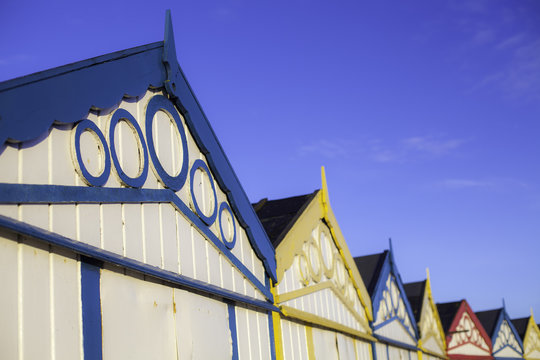 Row of seaside beach hut roof tops