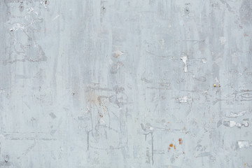 Close Up of Chipped blue peeling paint, torn ads Exterior Wall, 