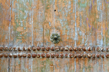 Old wooden background or texture with metal rivets and flower