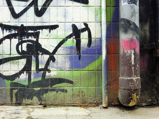 Urban ghetto pipe plumbing against grungy wall texture