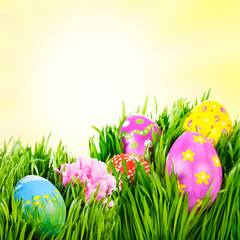 Hand painted Easter eggs nestled in the grass