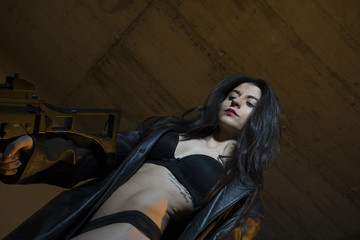 Police, Army brunette girl with gun in a garage in attitude shoo