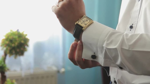 The man wears a watch
