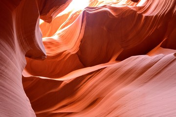 Bright Red Sandstone Rocks - Sunlight shines on colorful sandstone rocks in a high desert slot canyon. 