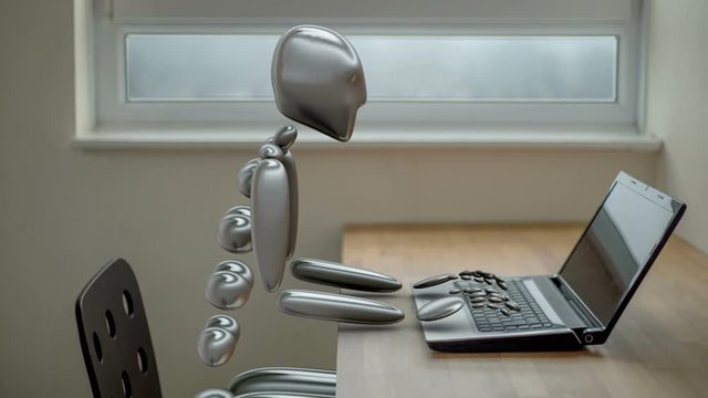 Robot office worker using a laptop computer.