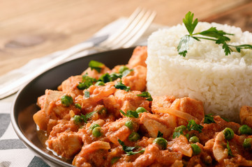 Chicken fillet in tomato sauce with boiled rice.