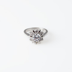 Luxury jewelry, shopping, wedding concept. White gold or silver ring with diamonds. Selective focus.
