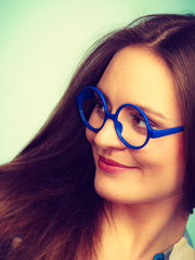 Happy smiling nerdy woman in weird glasses