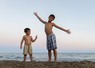 Little boys on the beach heaving fun