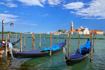 Obraz na płótnie Canvas Gondolas moored near San Marco square across from San Giorgio Ma