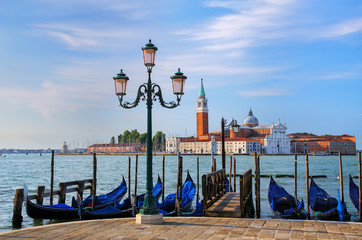 Fototapeta na wymiar Gondolas moored near San Marco square across from San Giorgio Ma