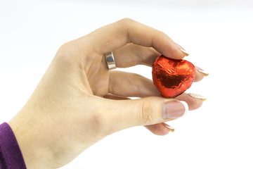 Woman's hand holding sweet red heart